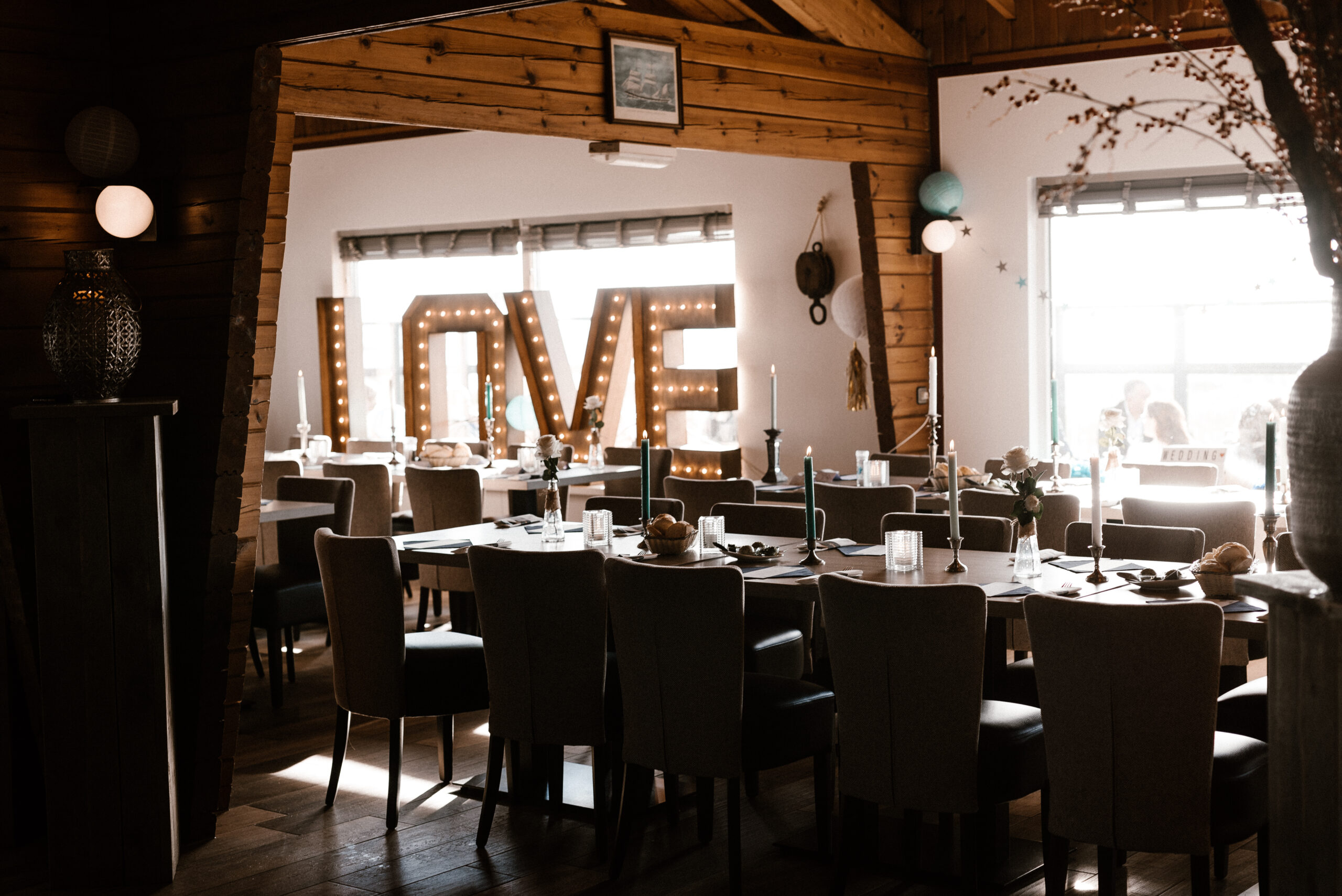Feestelijk gedekte zaal met LOVE-letters voor een bruiloft